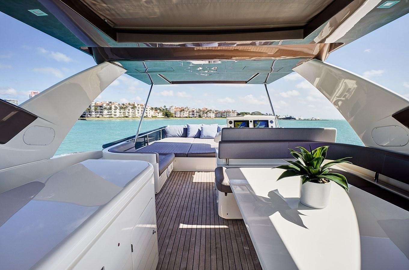a lounge area with a large white tent and a plant on the side aboard Mojo Yacht for Sale
