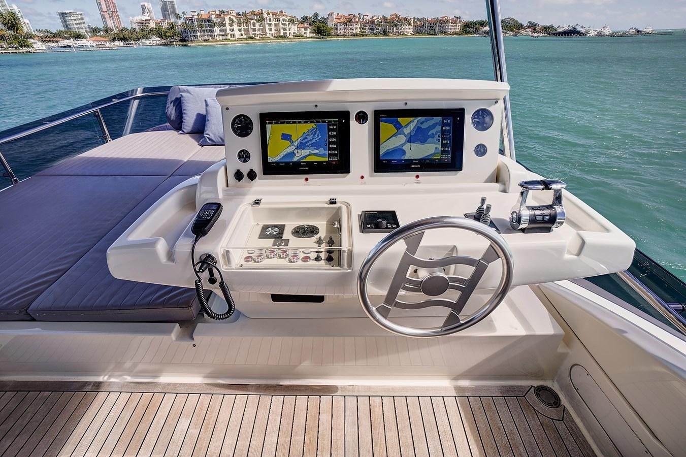 a white boat with a screen aboard Mojo Yacht for Sale