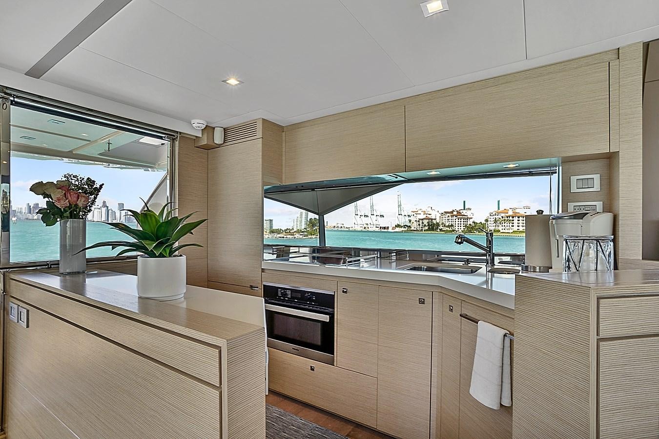 a kitchen with a glass window aboard Mojo Yacht for Sale