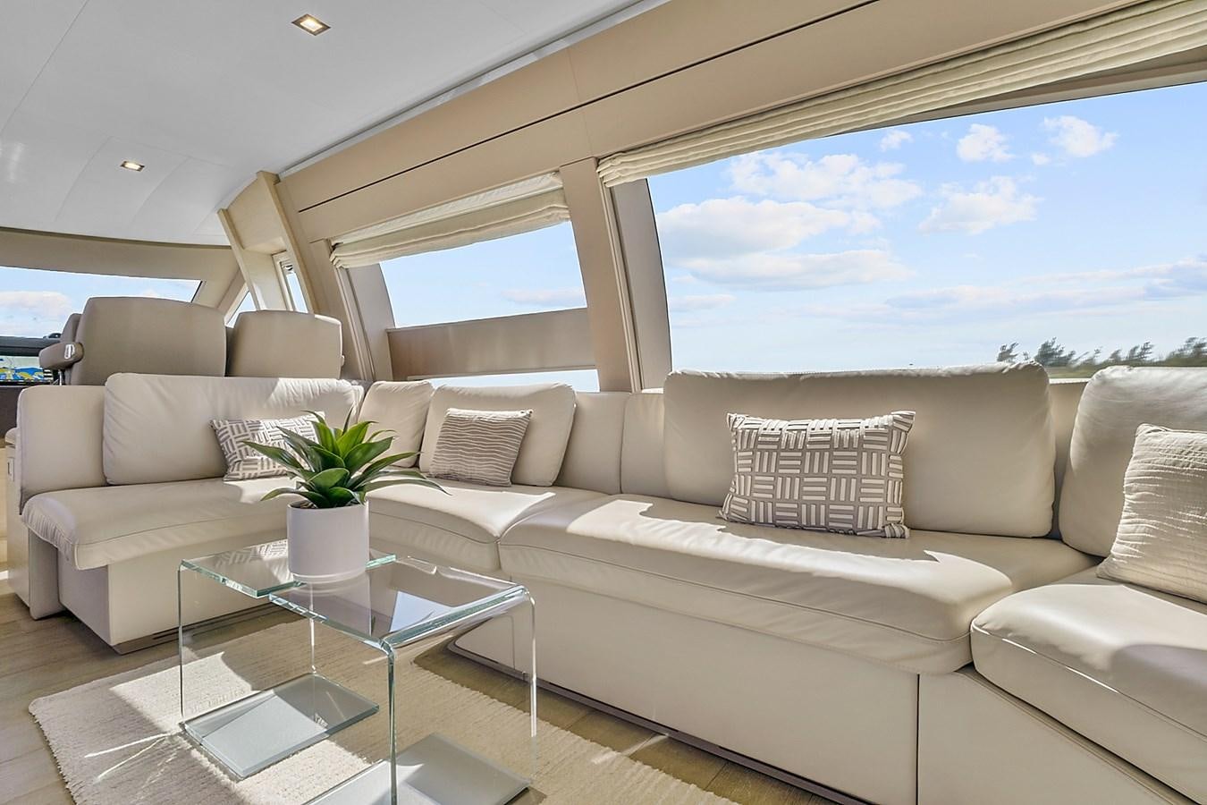 a living room with a large window aboard Mojo Yacht for Sale