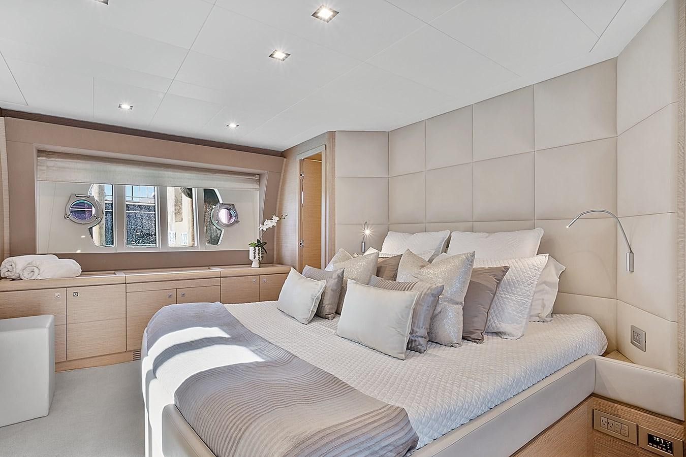 a bedroom with a bed and a window aboard Mojo Yacht for Sale