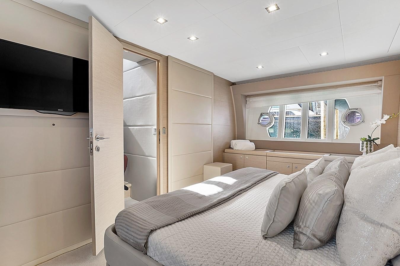 a bedroom with a bed and a television aboard Mojo Yacht for Sale