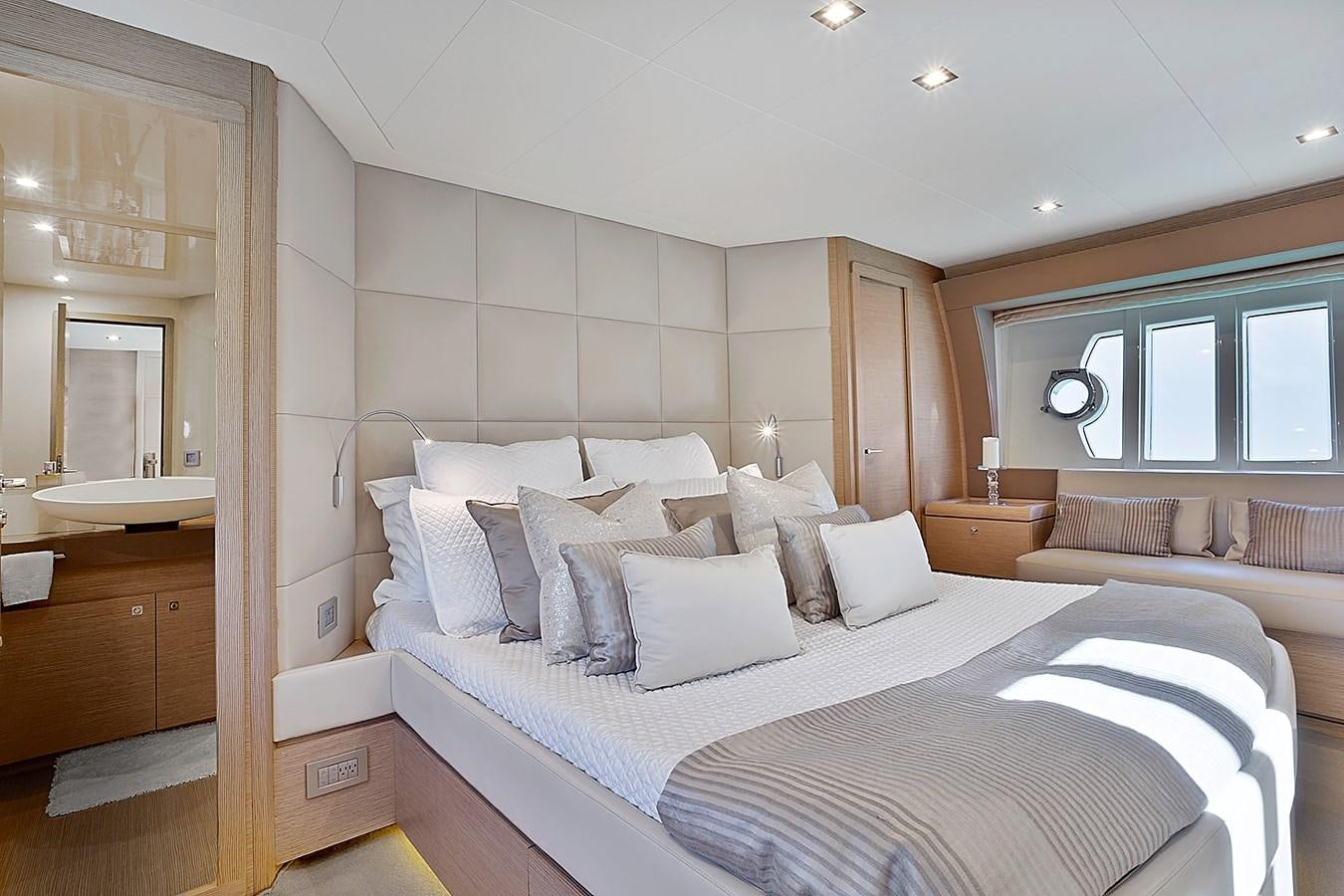 a bedroom with a bed and a couch aboard Mojo Yacht for Sale