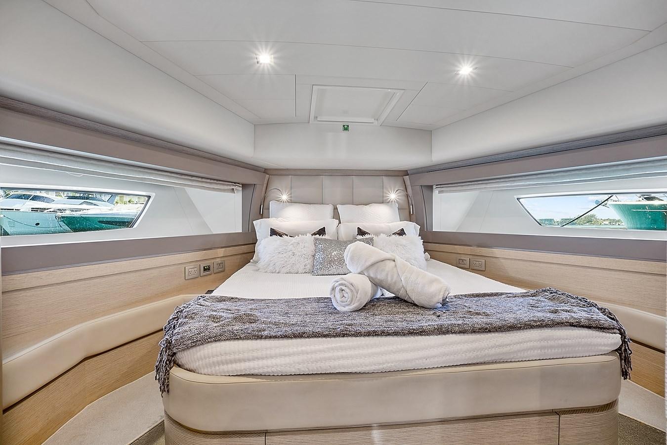 a bed with white sheets aboard Mojo Yacht for Sale