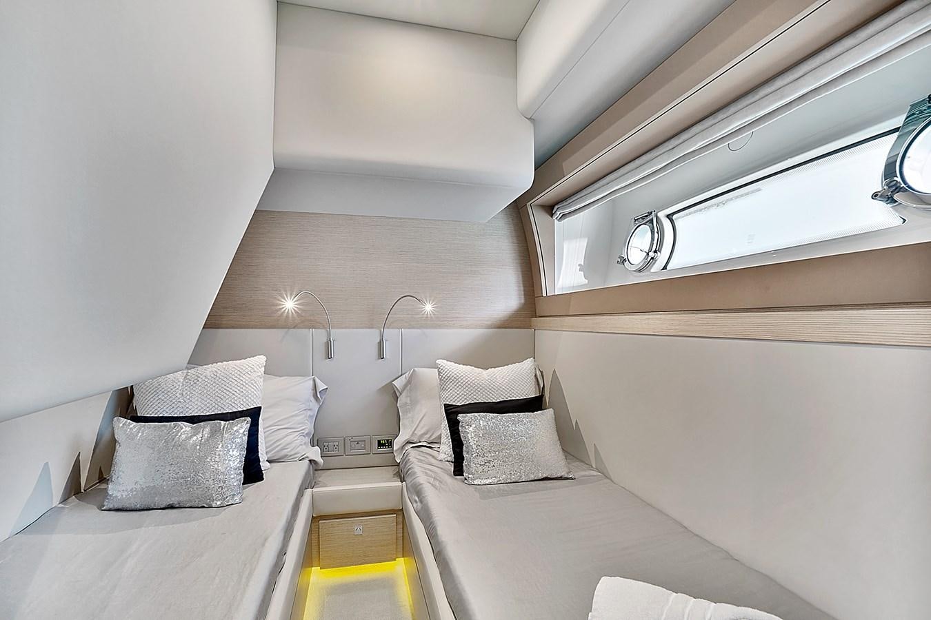 a room with two beds aboard Mojo Yacht for Sale