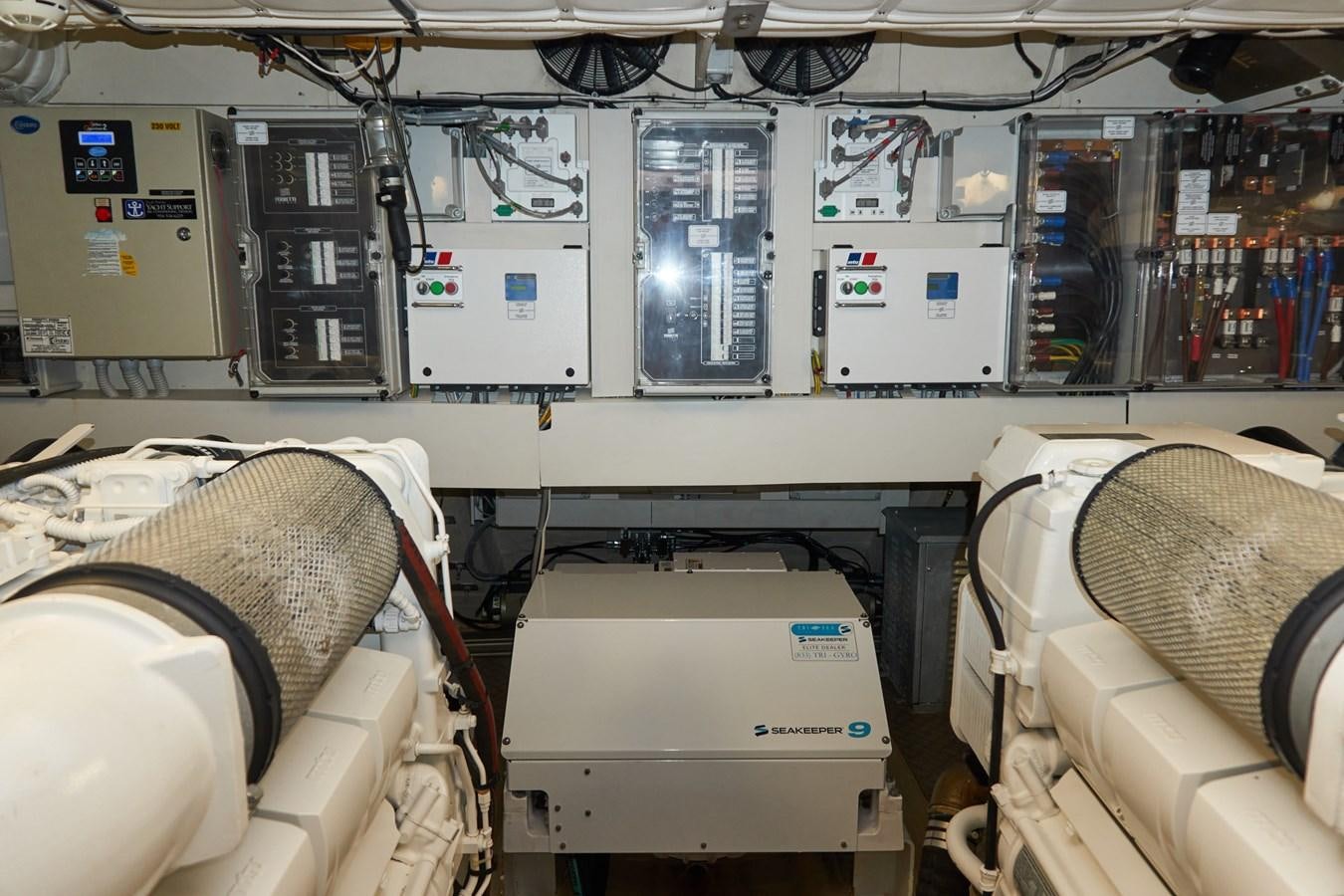 a room with a computer and other electronic devices aboard Mojo Yacht for Sale