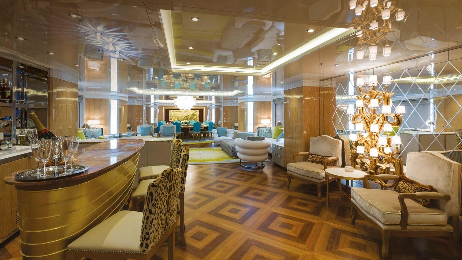 a fancy lounge area with a chandelier aboard SEAKID II Yacht for Sale
