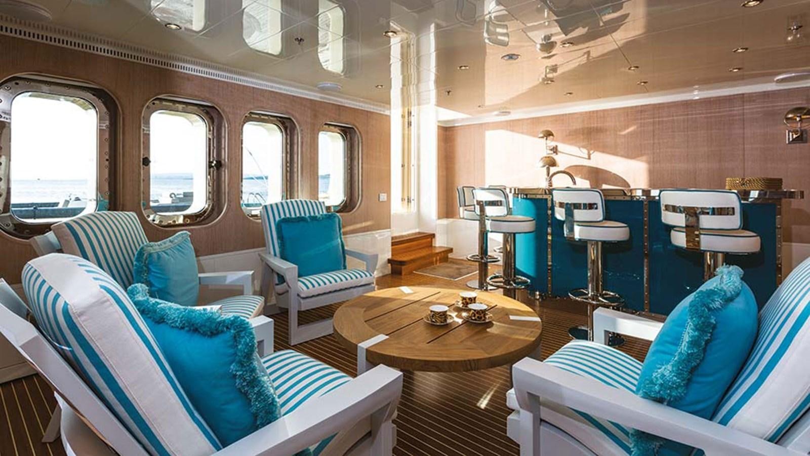 a train car with a table and chairs aboard SEAKID II Yacht for Sale