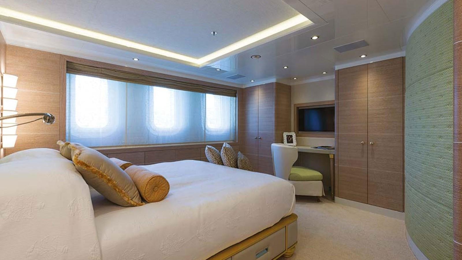 a bedroom with a bed and a desk aboard SEAKID II Yacht for Sale