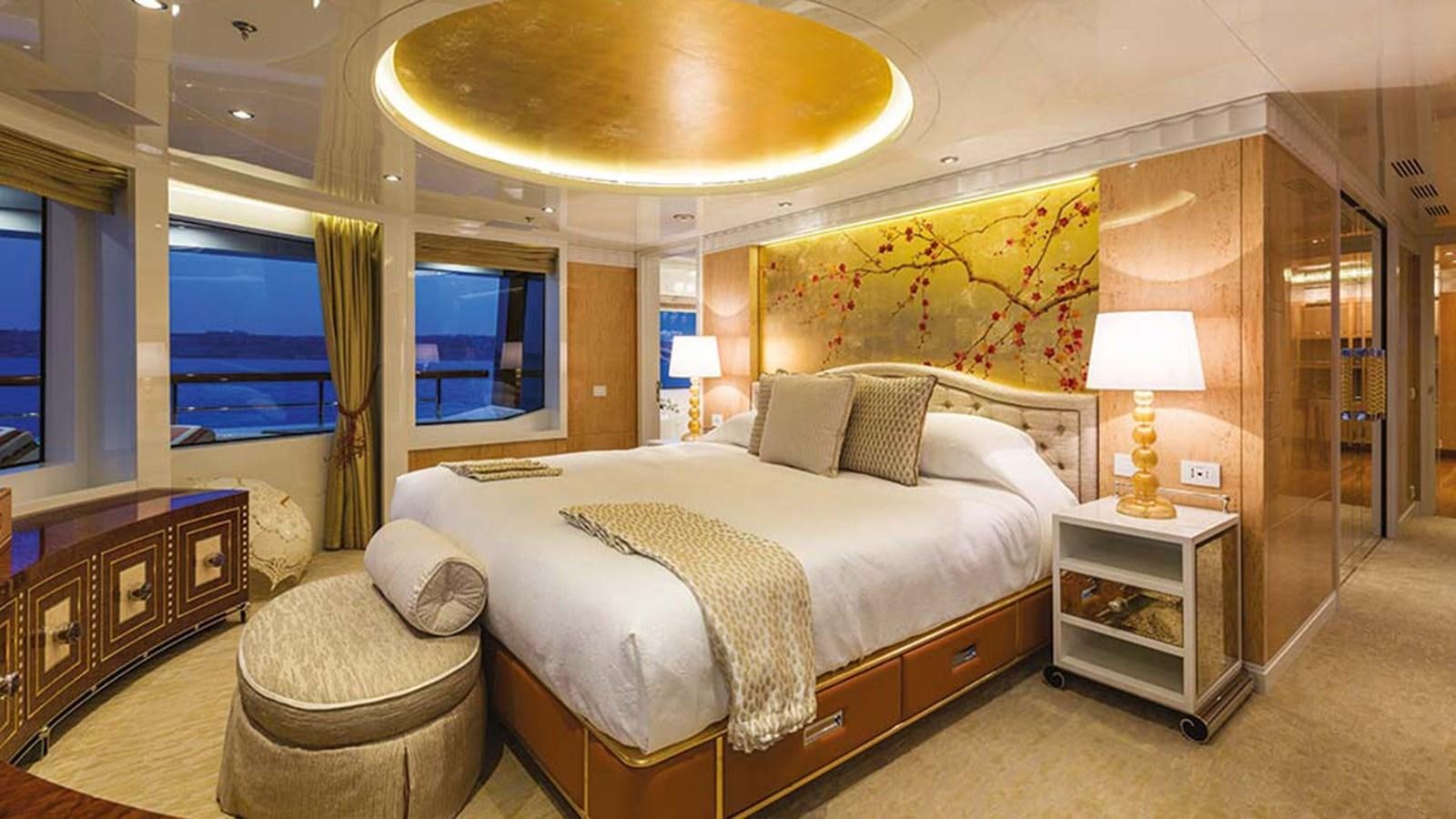 a bedroom with a bed and a desk aboard SEAKID II Yacht for Sale