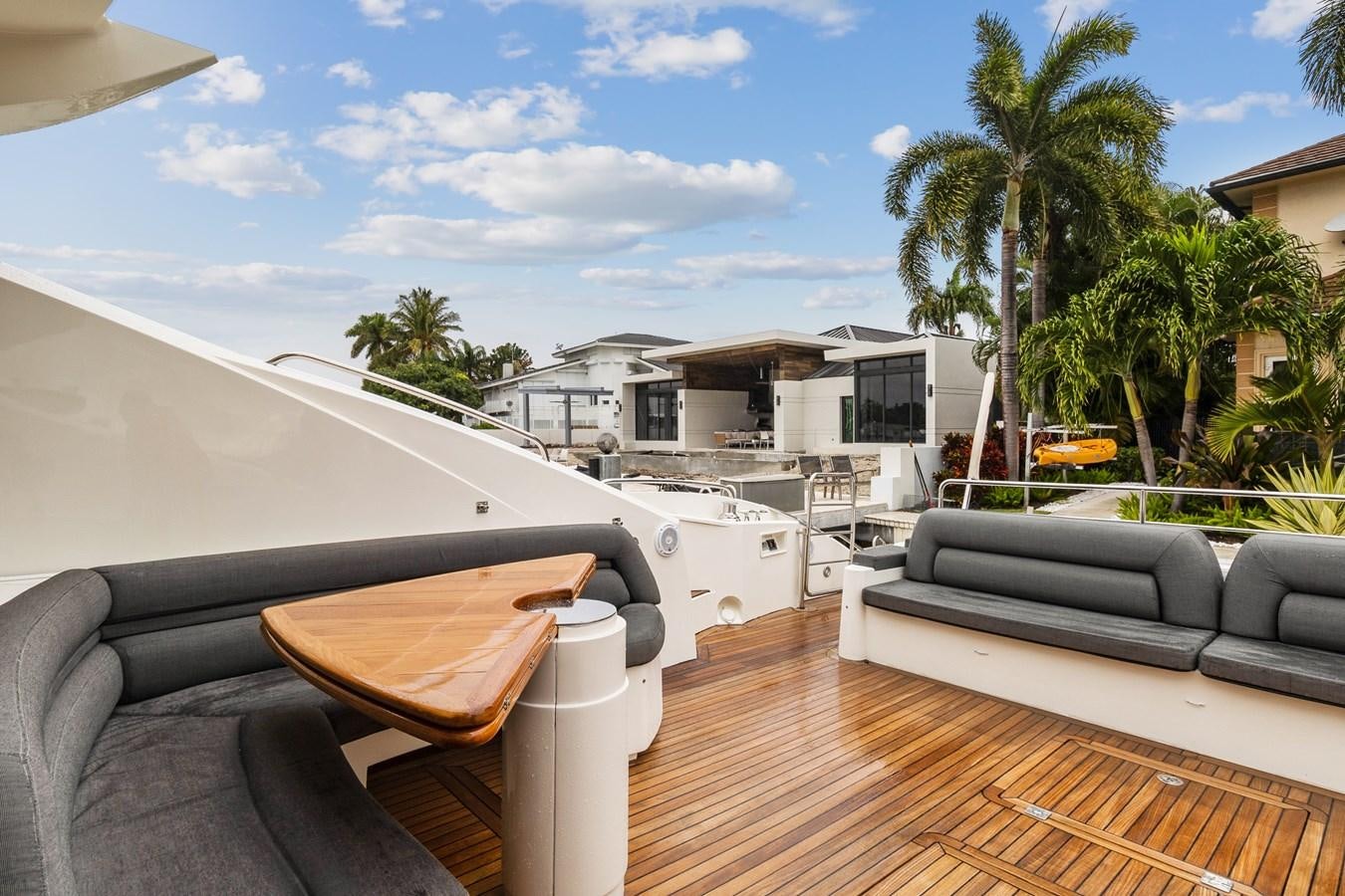 a deck with a pool and a deck with chairs and trees aboard HER WAY Yacht for Sale