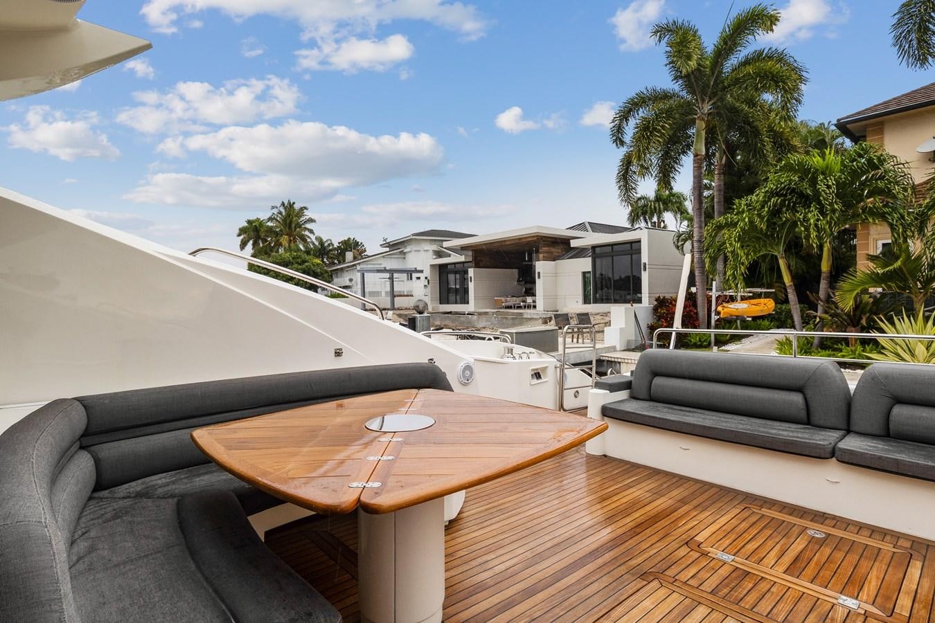 a table and chairs outside of a house aboard HER WAY Yacht for Sale