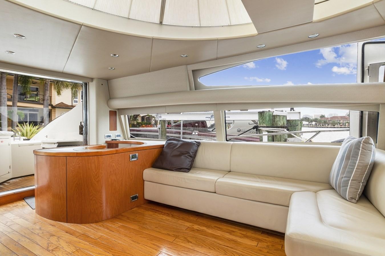 a living room with a couch and a large window aboard HER WAY Yacht for Sale