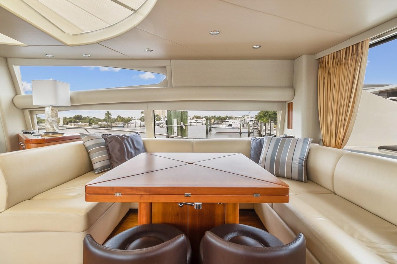 a living room with a table and couches aboard HER WAY Yacht for Sale