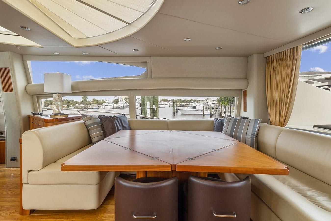 a living room with a large table aboard HER WAY Yacht for Sale