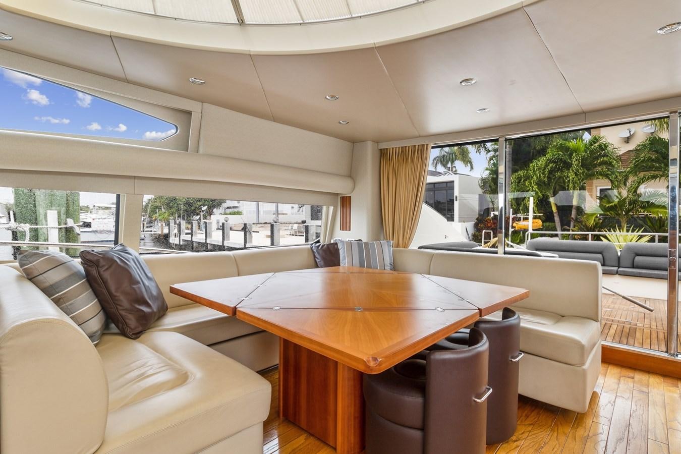 a living room with a table and chairs aboard HER WAY Yacht for Sale