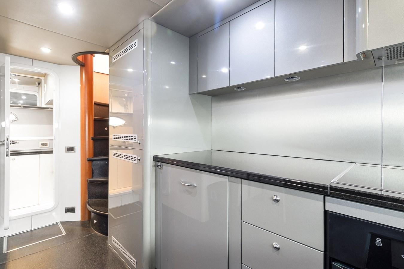 a kitchen with cabinets and a shelf aboard HER WAY Yacht for Sale