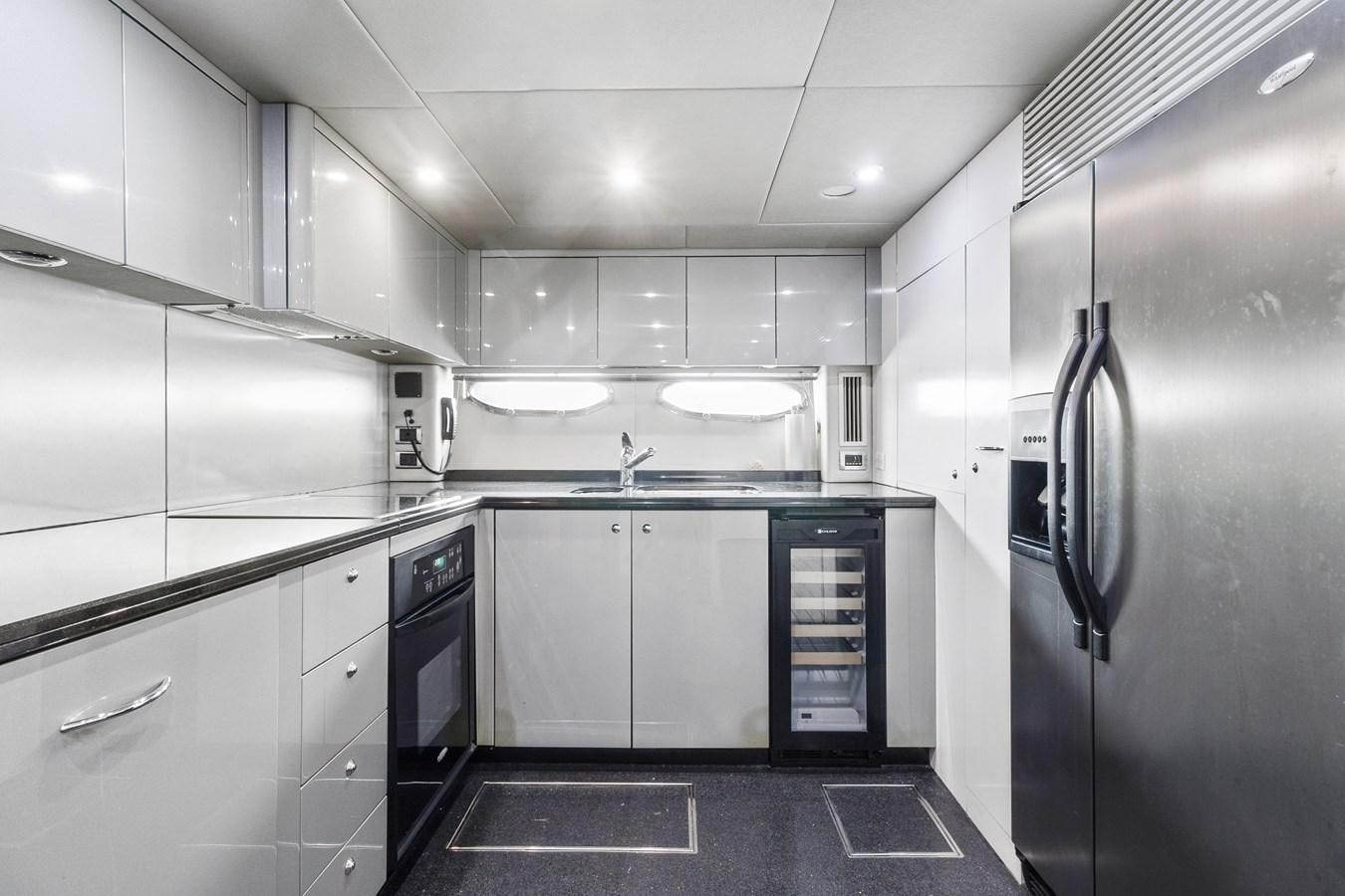 a kitchen with white cabinets aboard HER WAY Yacht for Sale