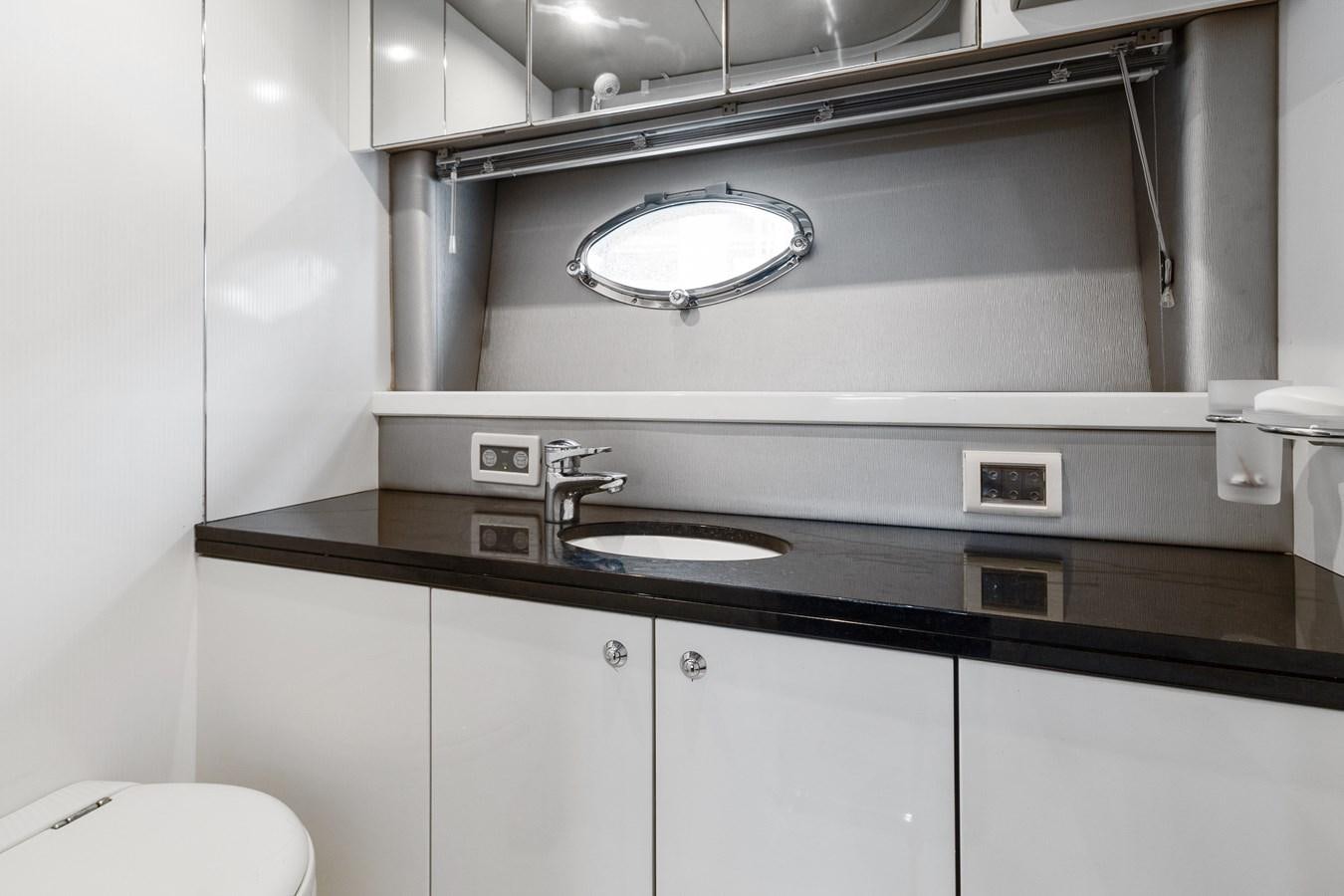 a kitchen with a sink and a mirror aboard HER WAY Yacht for Sale
