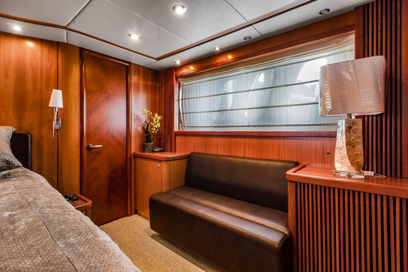 a room with a couch and a lamp aboard HER WAY Yacht for Sale