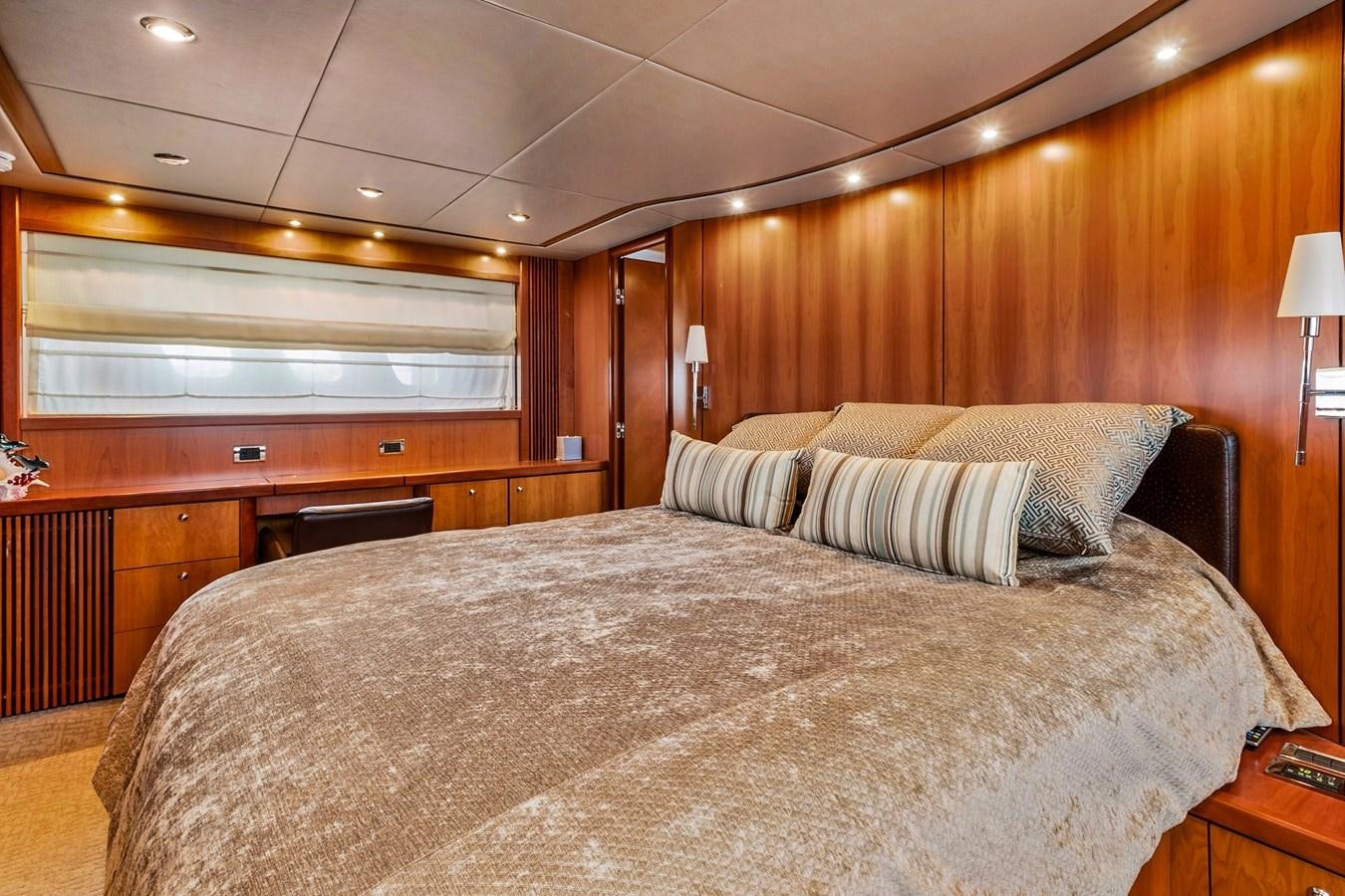 a bed with a white comforter aboard HER WAY Yacht for Sale