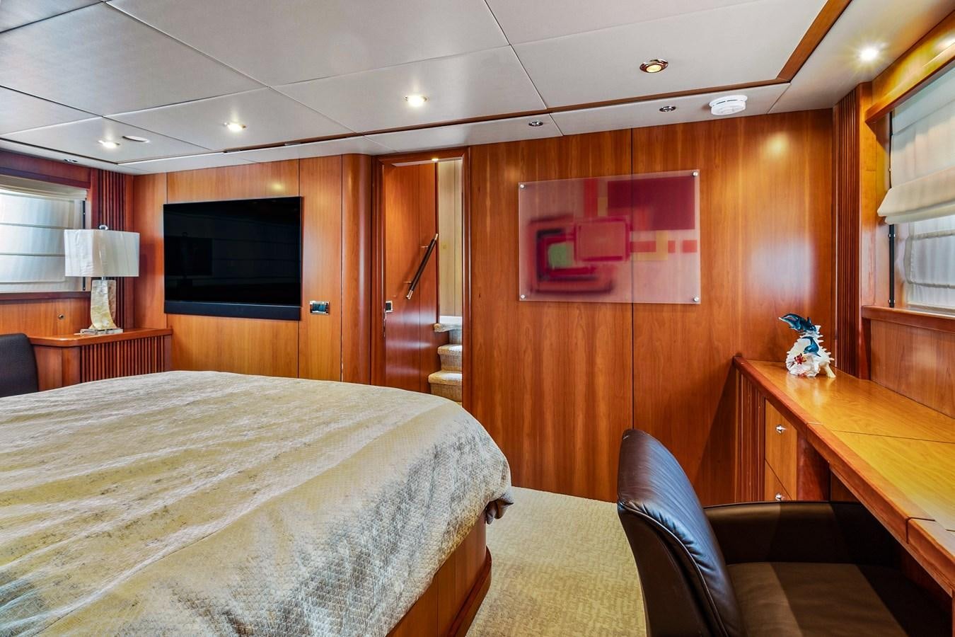a bedroom with a bed and a television aboard HER WAY Yacht for Sale