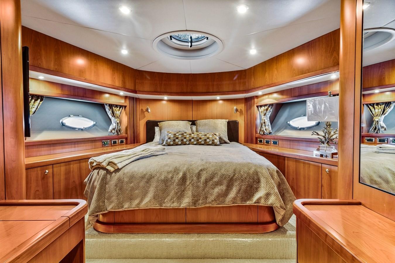a bed with a mirror above it aboard HER WAY Yacht for Sale