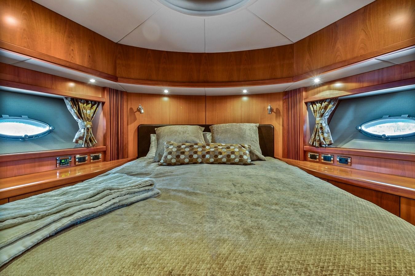 a bed with a large mirror above it aboard HER WAY Yacht for Sale