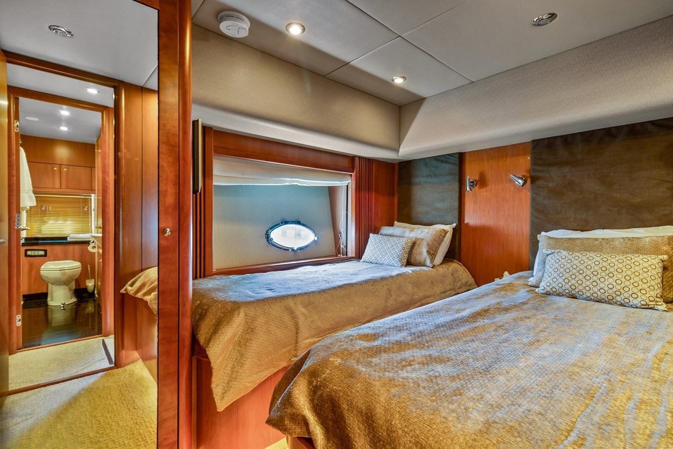 a bedroom with a bed and a mirror aboard HER WAY Yacht for Sale
