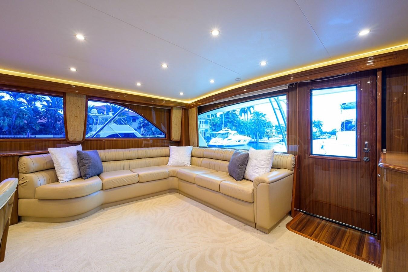 a living room with a couch and a large window aboard KNOT RACING Yacht for Sale