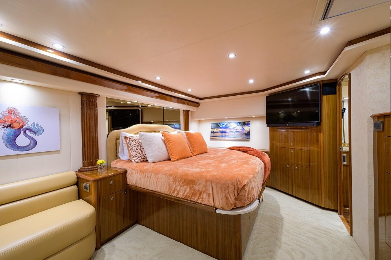 a bedroom with a bed and a television aboard KNOT RACING Yacht for Sale