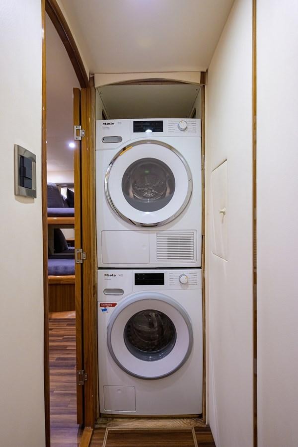 a washing machine in a room aboard KNOT RACING Yacht for Sale