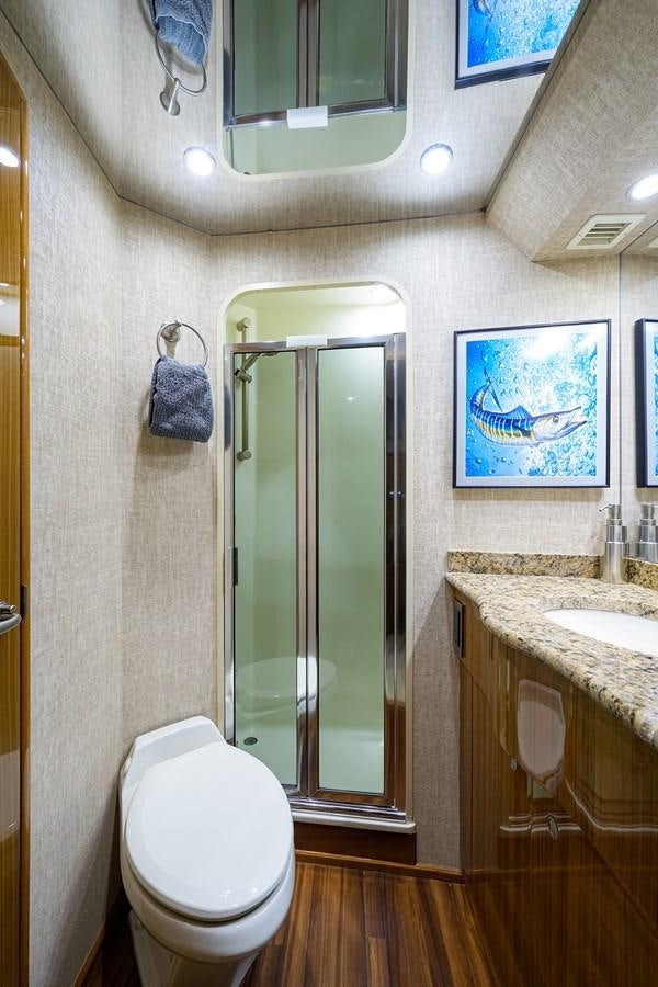 a bathroom with a glass shower door aboard KNOT RACING Yacht for Sale