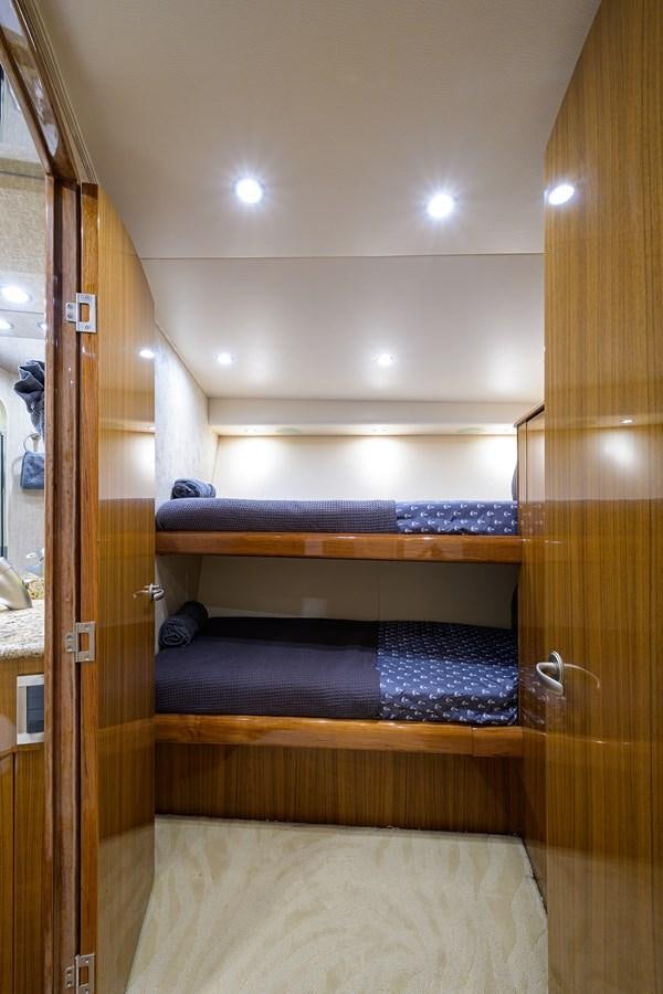 a room with a bed and a mirror aboard KNOT RACING Yacht for Sale