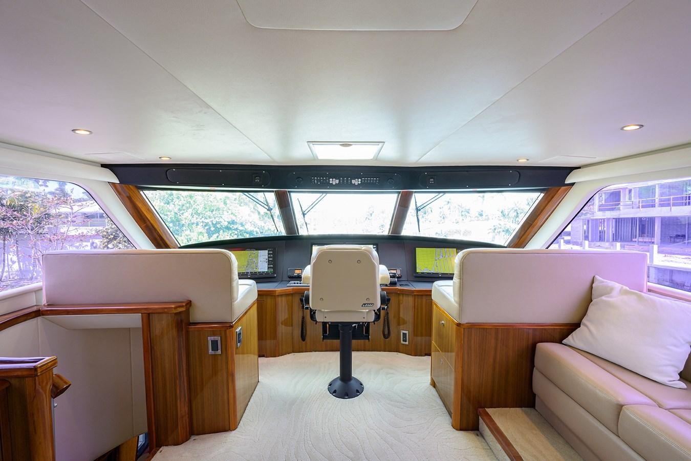 a room with a chair and a table and a couch aboard KNOT RACING Yacht for Sale