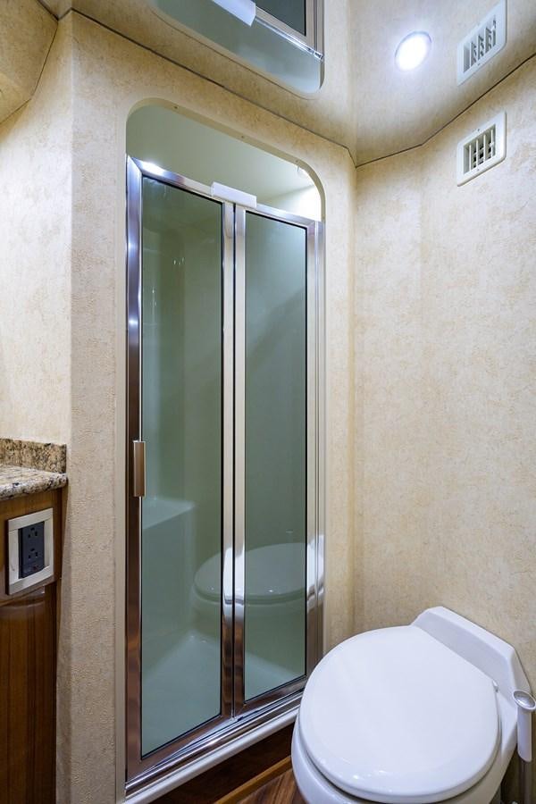 a bathroom with a glass shower aboard KNOT RACING Yacht for Sale