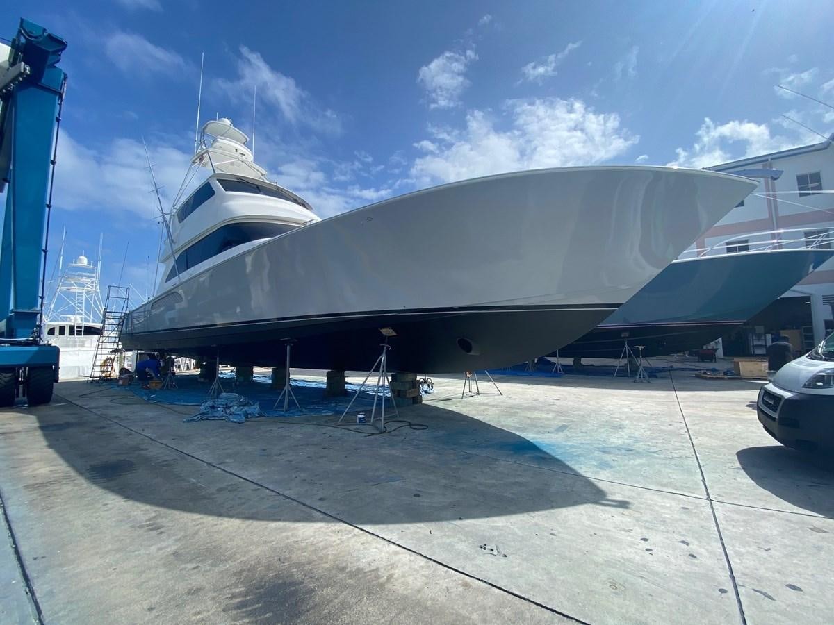 a large metal object with a large body of water in the background with London Aquatics Centre in the background aboard KNOT RACING Yacht for Sale