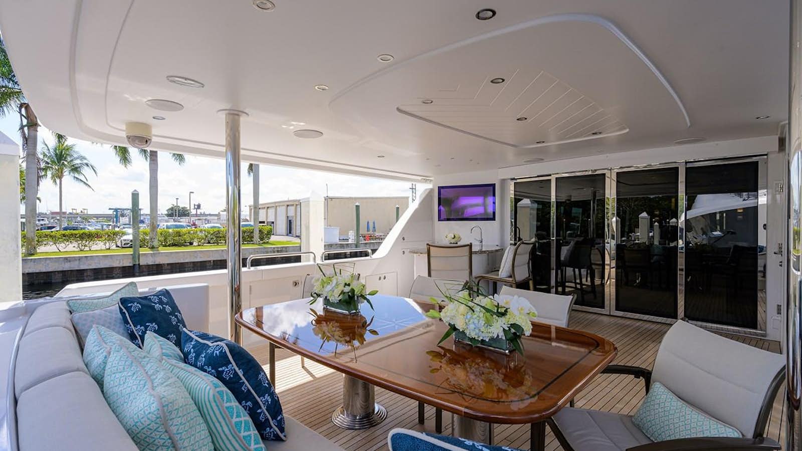 a large living room with a table and chairs aboard TIRELESS Yacht for Sale