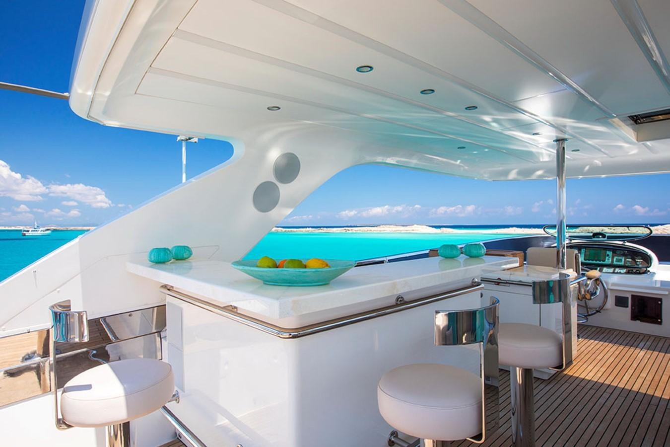 a pool with a table and chairs aboard ETOUPE Yacht for Sale