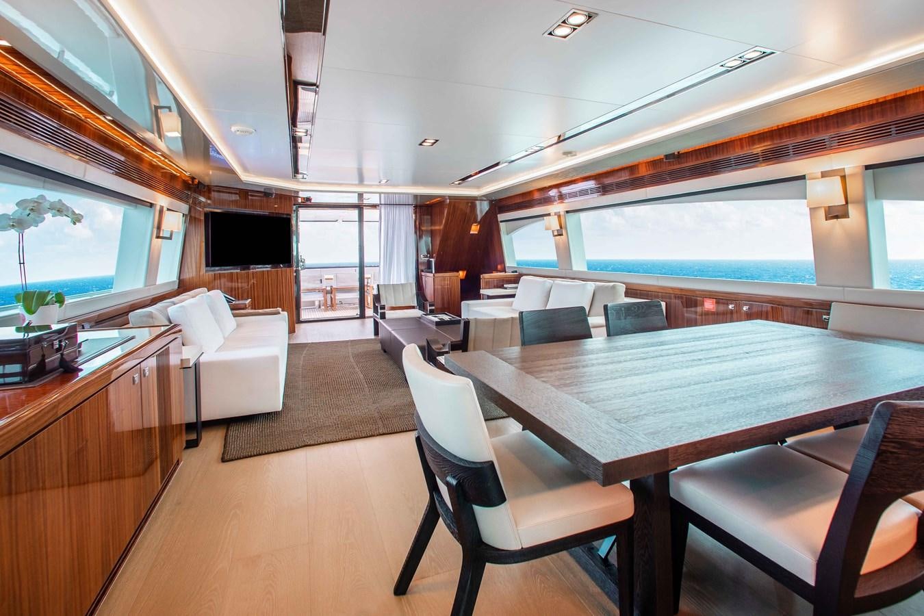 a large room with a table and chairs aboard ISLAND SOUL Yacht for Sale