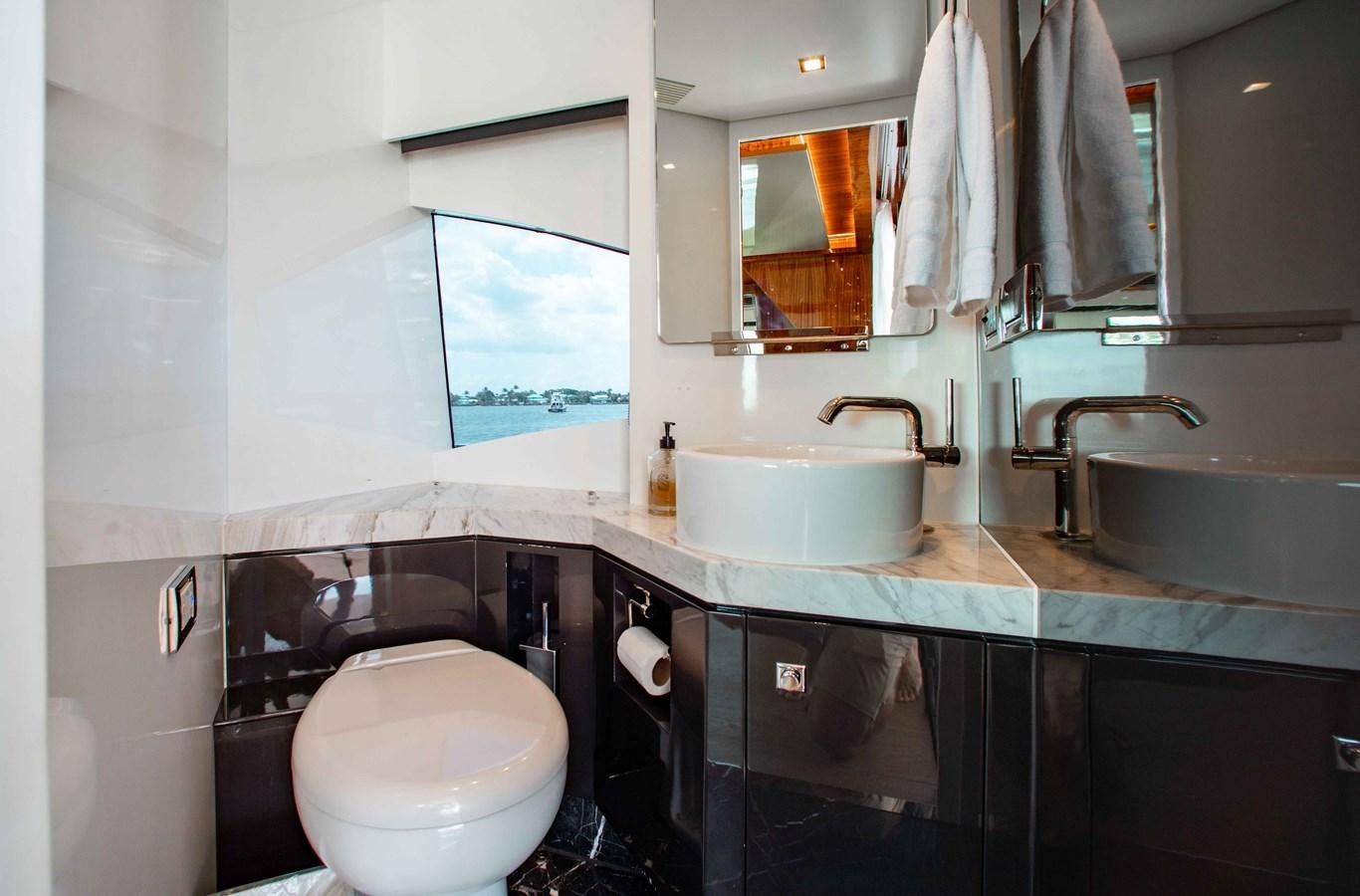 a bathroom with a toilet sink and a mirror aboard ISLAND SOUL Yacht for Sale
