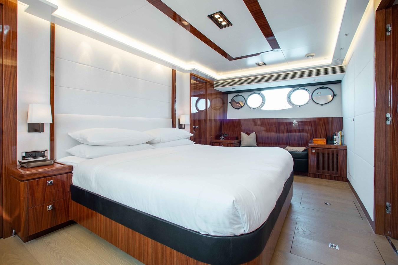 a bedroom with a bed and a desk aboard ISLAND SOUL Yacht for Sale