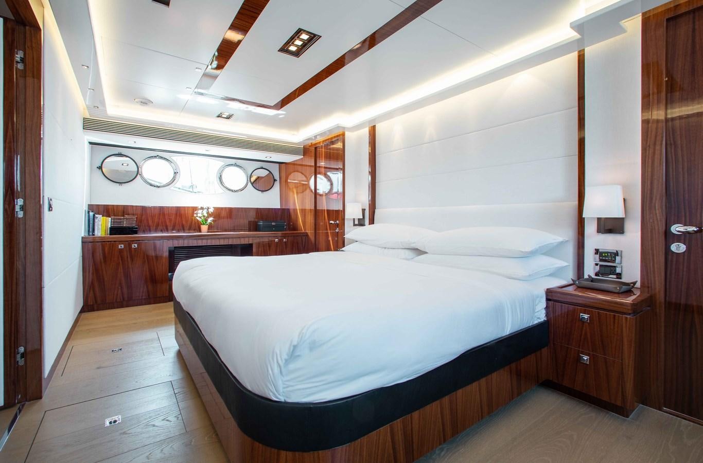 a bedroom with a bed and a desk aboard ISLAND SOUL Yacht for Sale