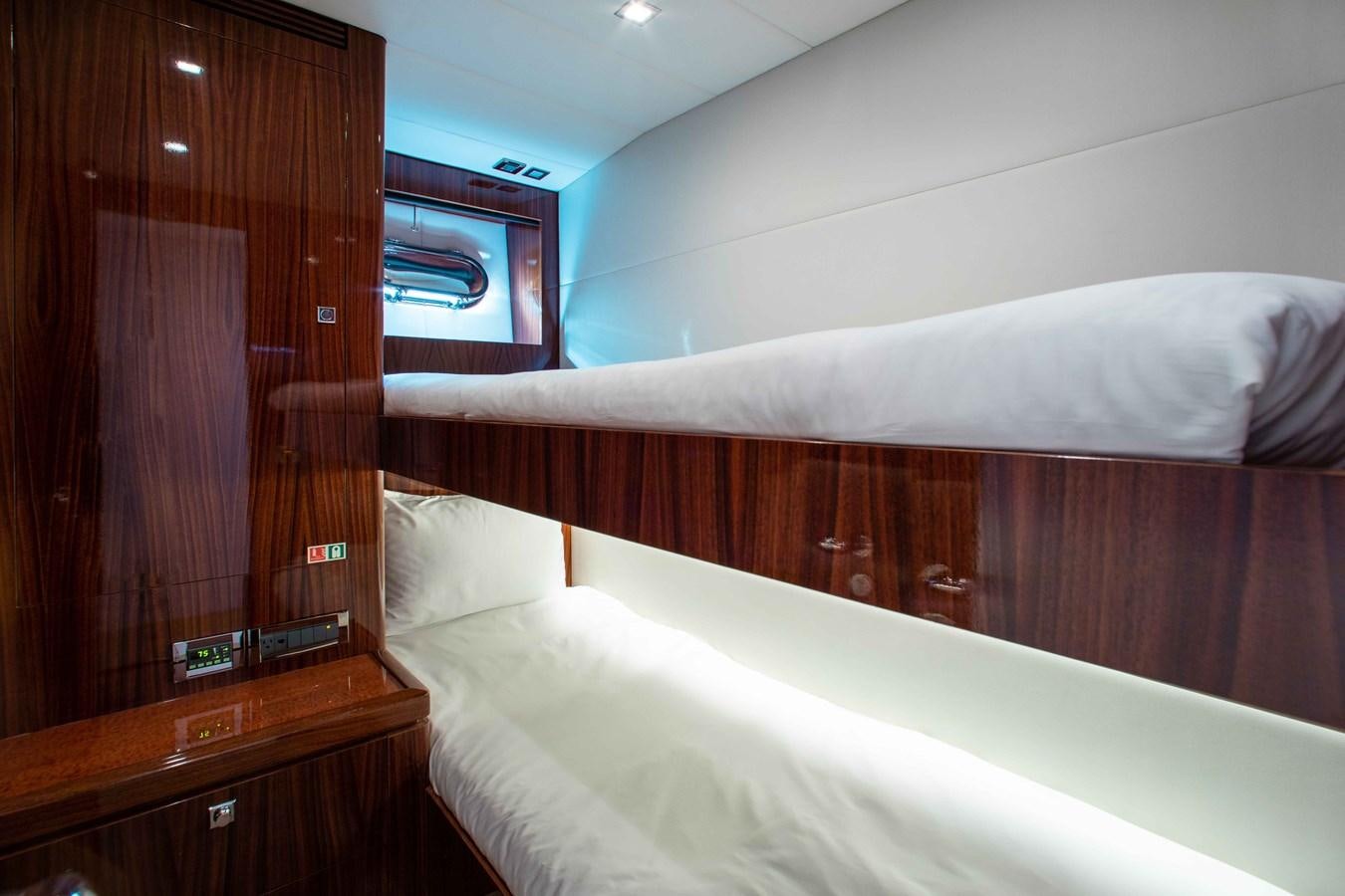 a bed with a wooden headboard aboard ISLAND SOUL Yacht for Sale