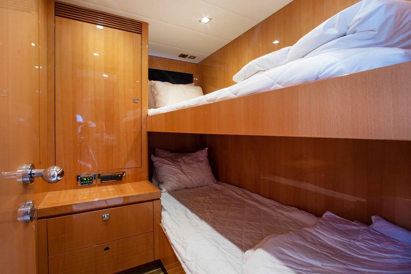 a bed with a wooden headboard aboard ISLAND SOUL Yacht for Sale
