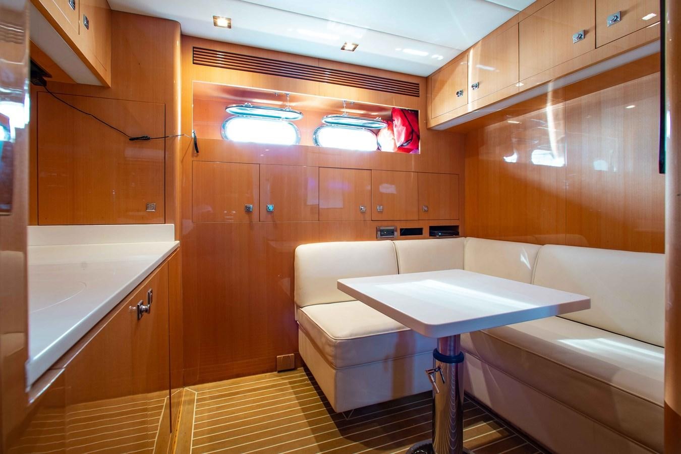 a room with a table and chairs aboard ISLAND SOUL Yacht for Sale