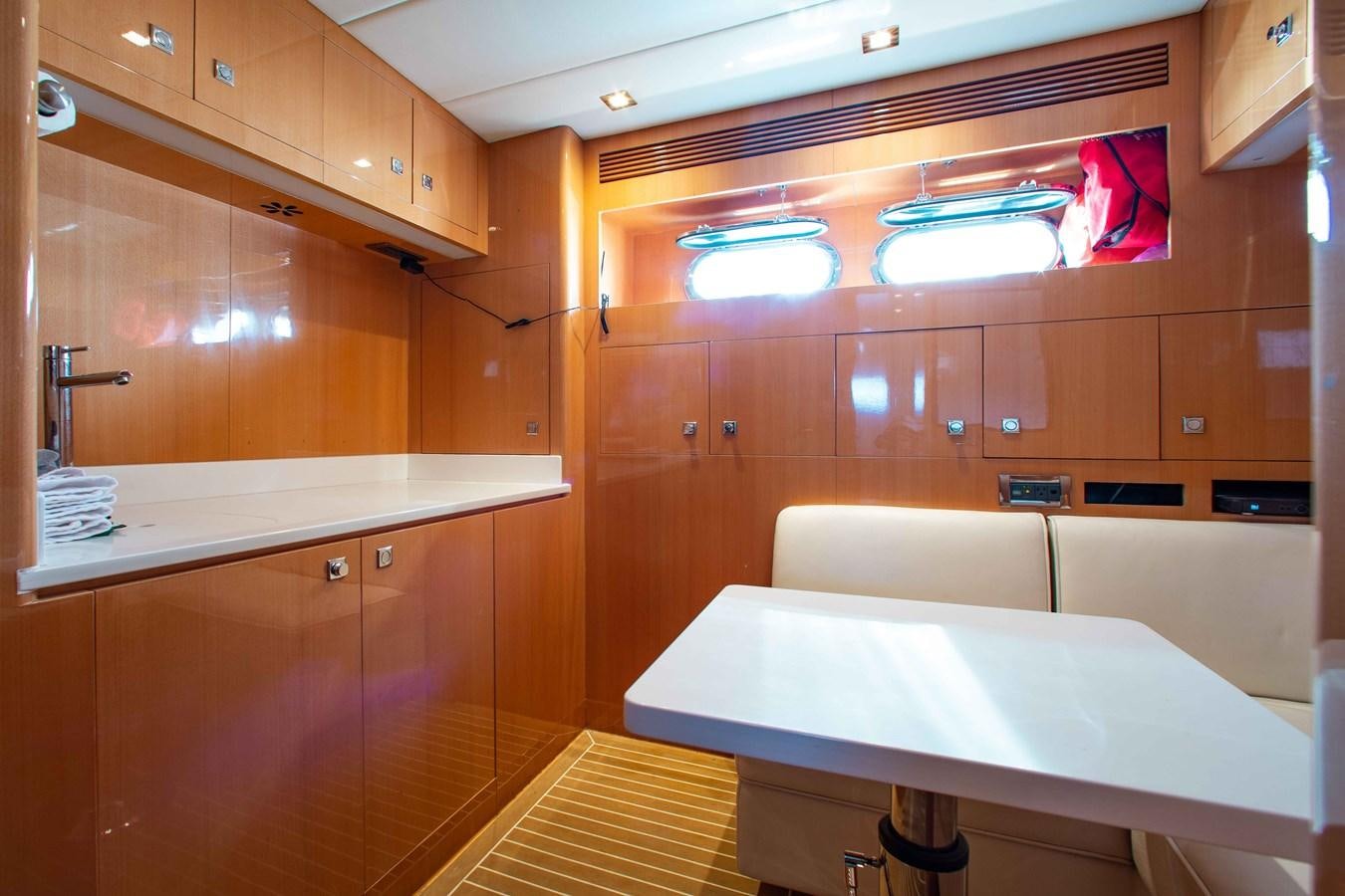 a kitchen with a table and chairs aboard ISLAND SOUL Yacht for Sale