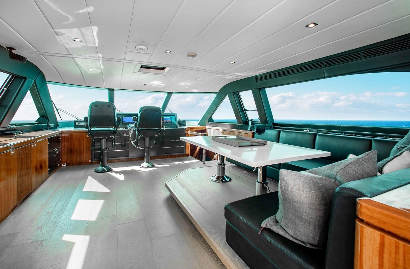 inside of a vehicle with a table and chairs and a couch aboard ISLAND SOUL Yacht for Sale