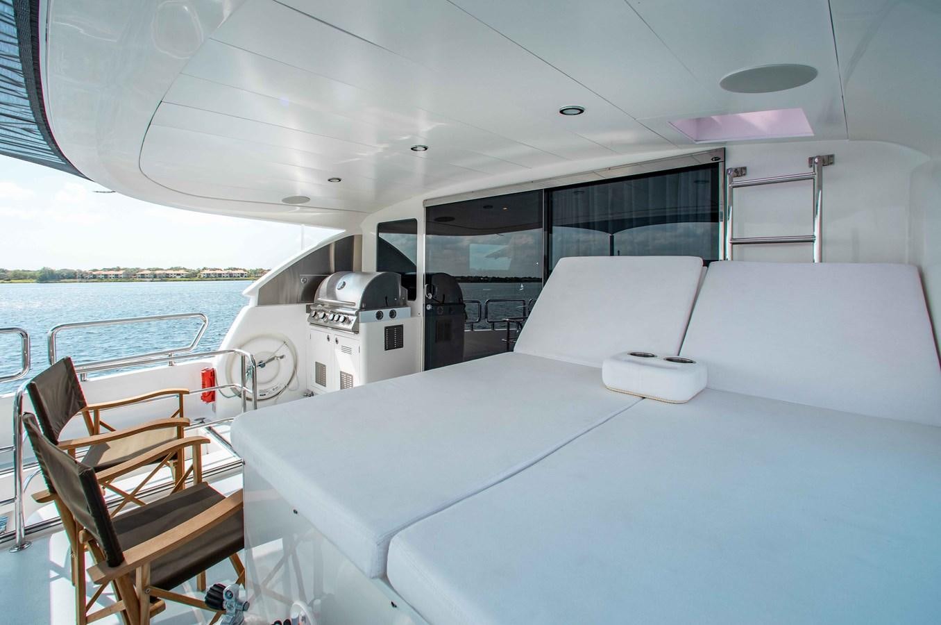 a boat with a white table and chairs on it aboard ISLAND SOUL Yacht for Sale