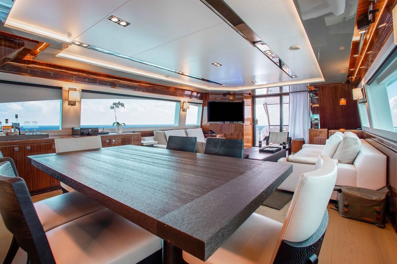a large room with a table and chairs aboard ISLAND SOUL Yacht for Sale